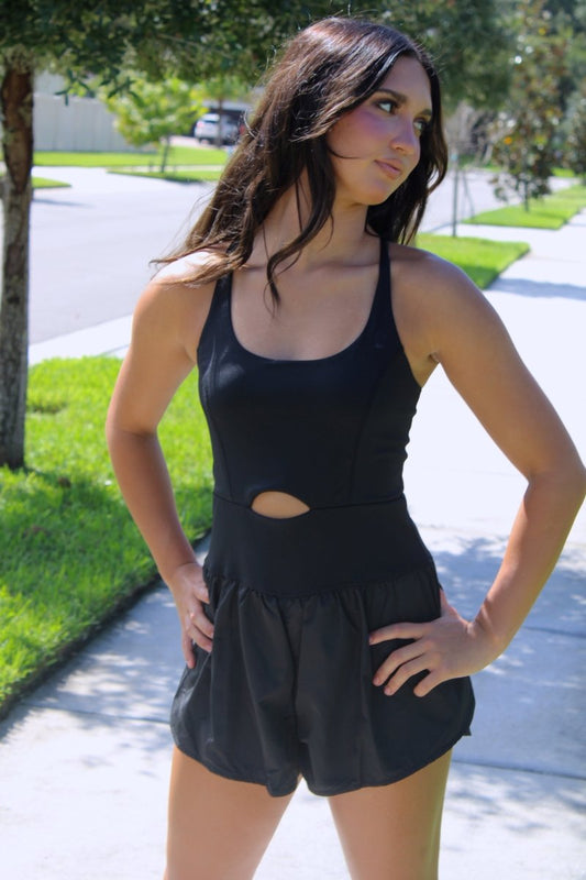 ShopJenny Boutique model is pictured wearing Cynthia Cutout Athletic Romper - Black made by TCEC.