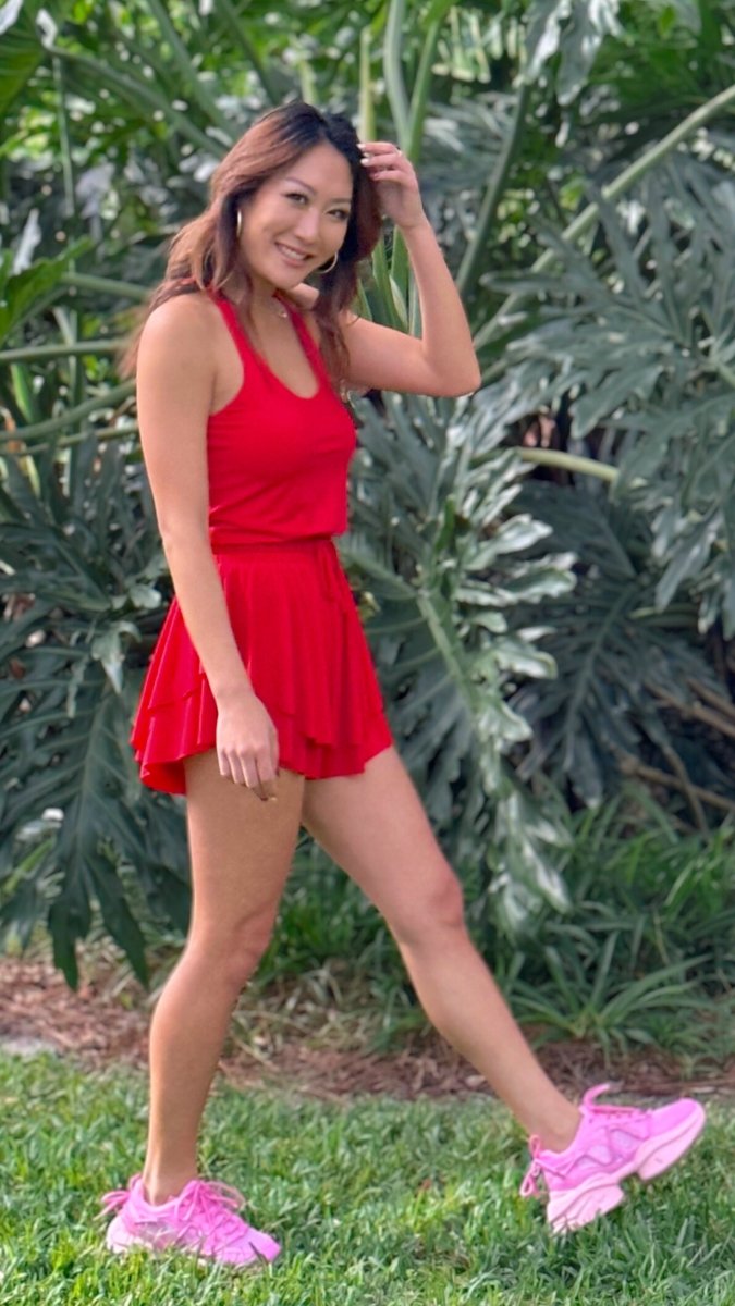 ShopJenny Boutique model is pictured wearing Mykaela Active Romper - Red made by TCEC.