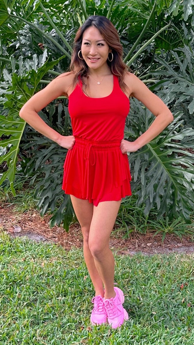 ShopJenny Boutique model is pictured wearing Mykaela Active Romper - Red made by TCEC.